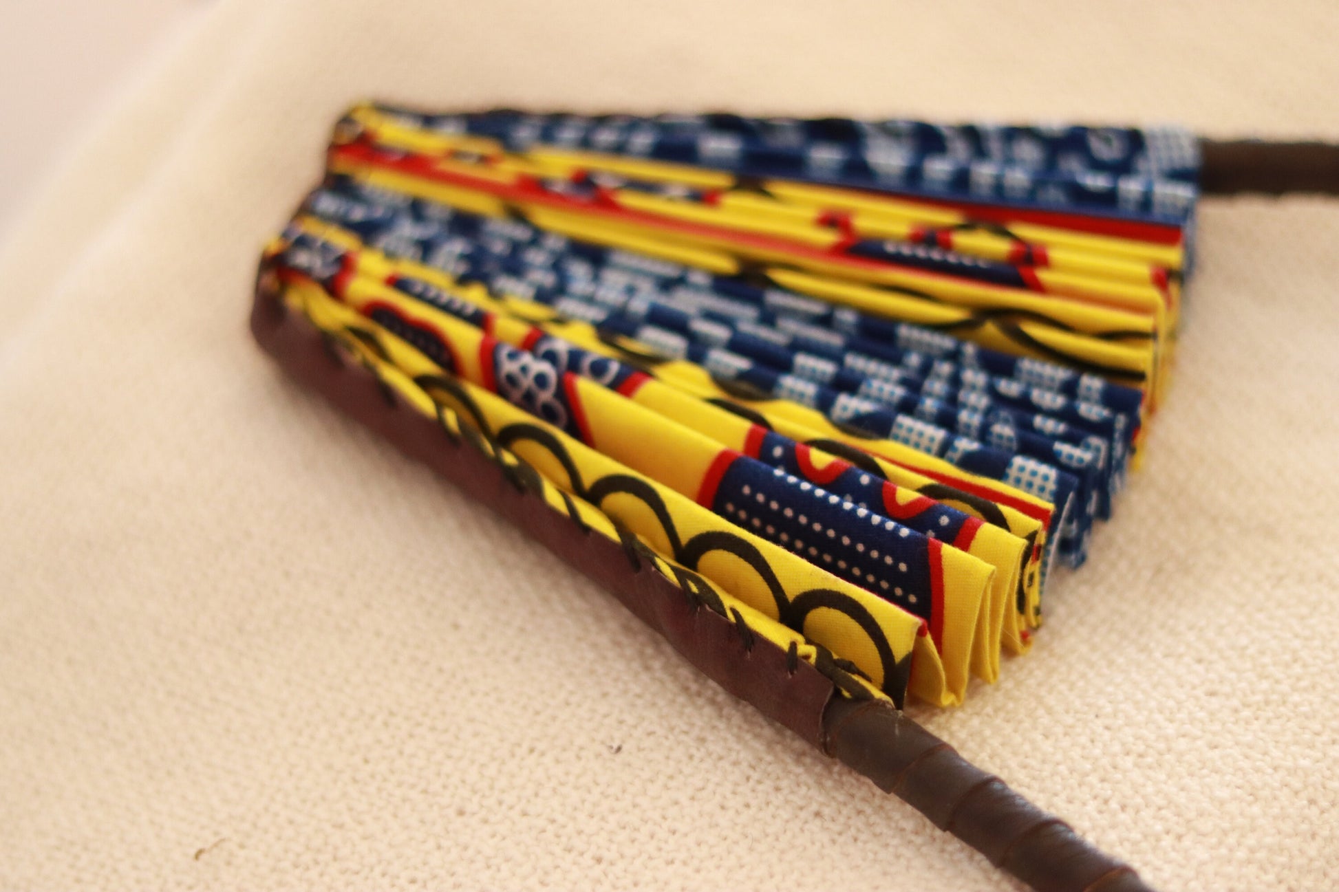 Bamileke Ndop Hand Fan: Handcrafted African Folding Accessory with Traditional Fabric Print