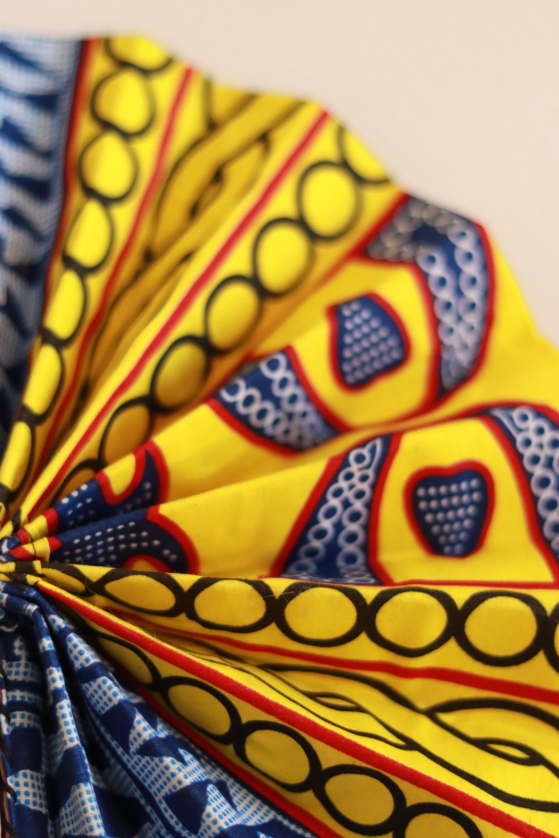 Bamileke Ndop Hand Fan: Handcrafted African Folding Accessory with Traditional Fabric Print